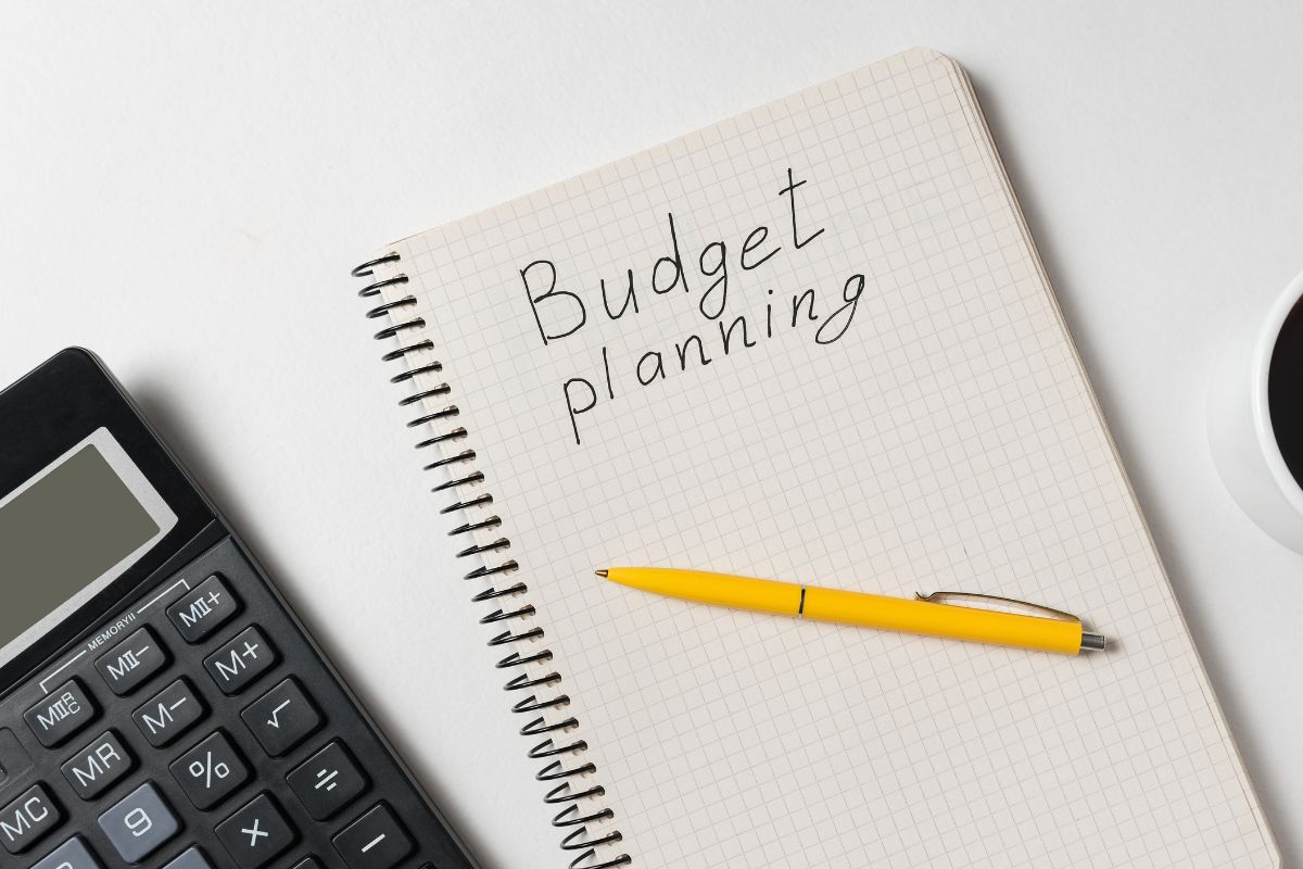 Photo of a notebook with budget planning wording.