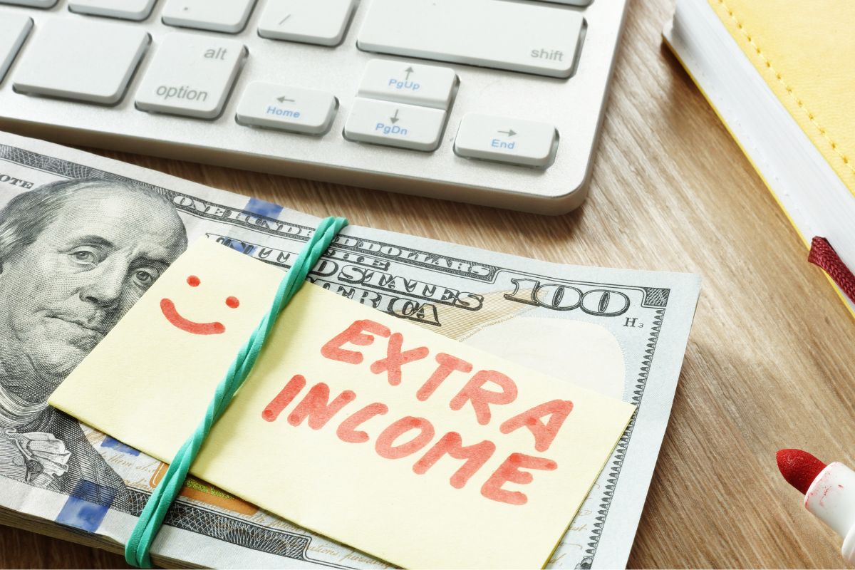 Image of extra income money and a keyboard.