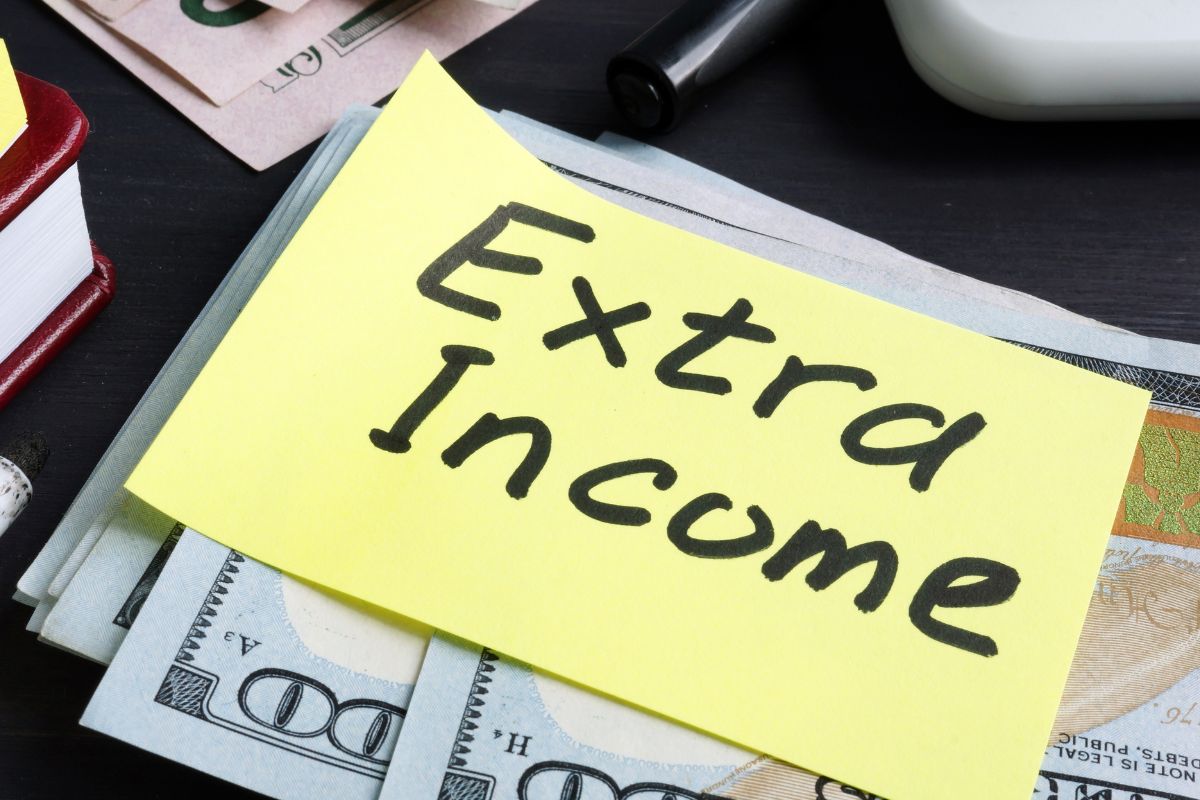 A paper with extra income wording and money.