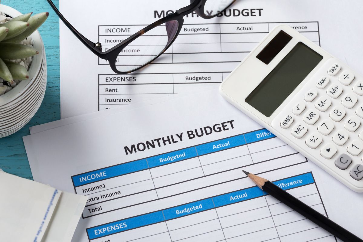 Photo of monthly budget papers and a calculator.