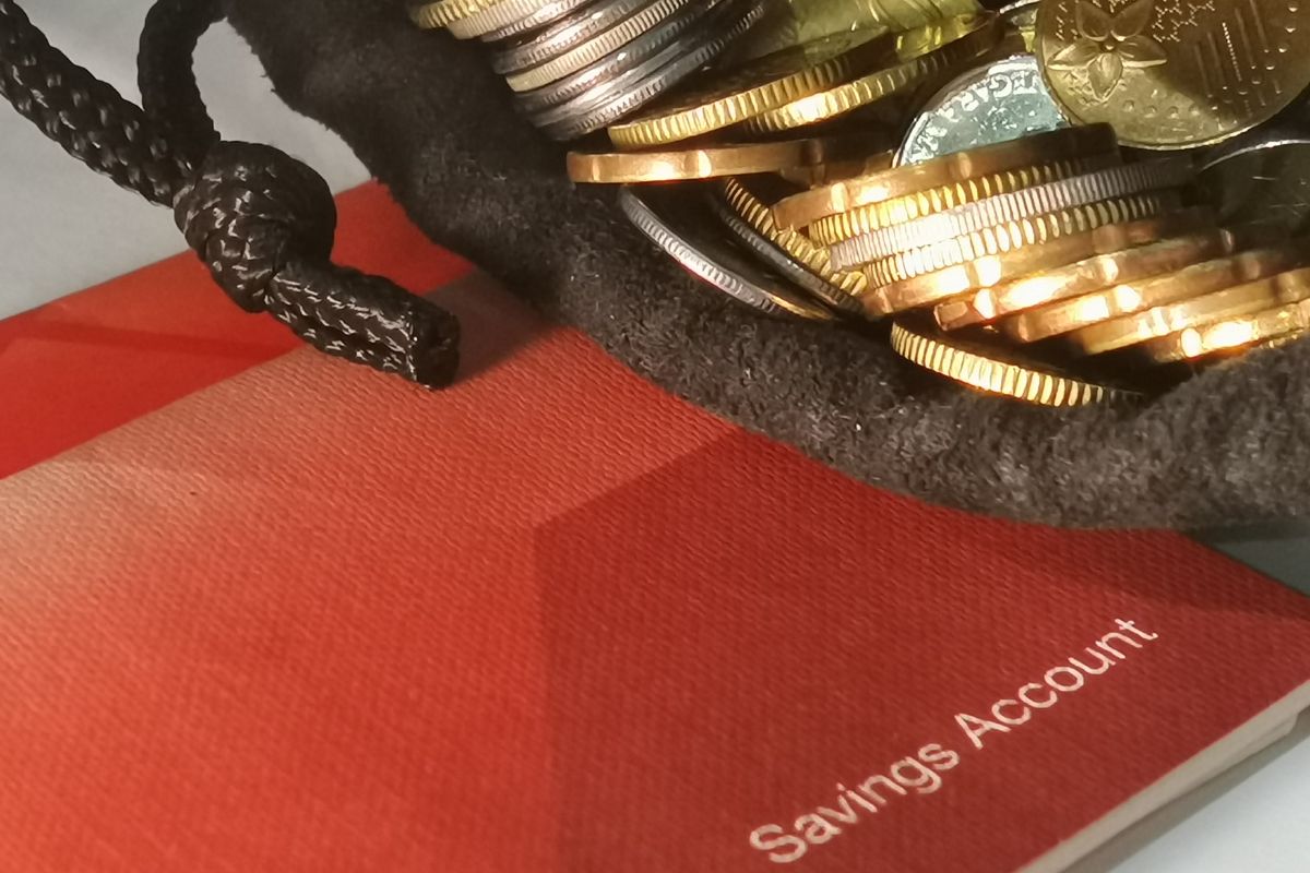 Picture of a bag of coins and a savings account.