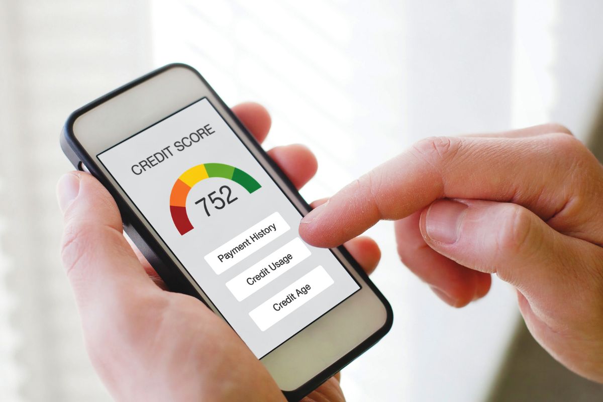 A man's hand checking his credit score.