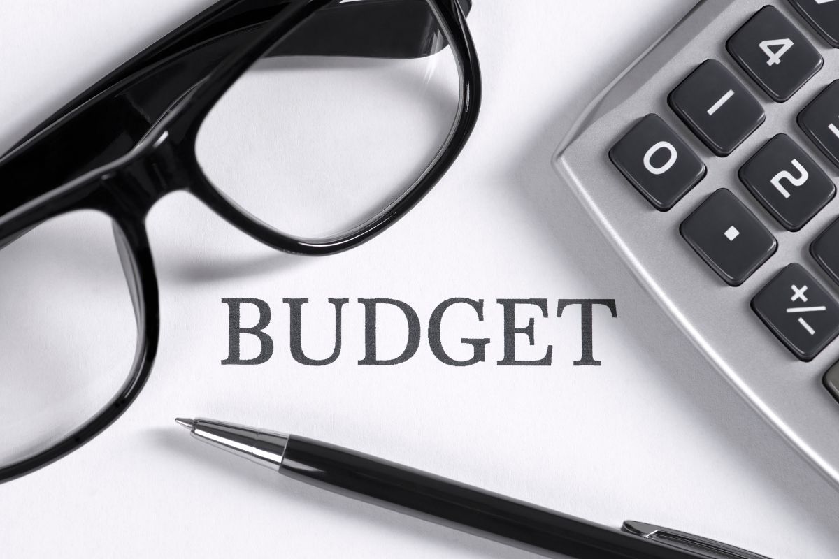 Picture of a calculator and budget wording.