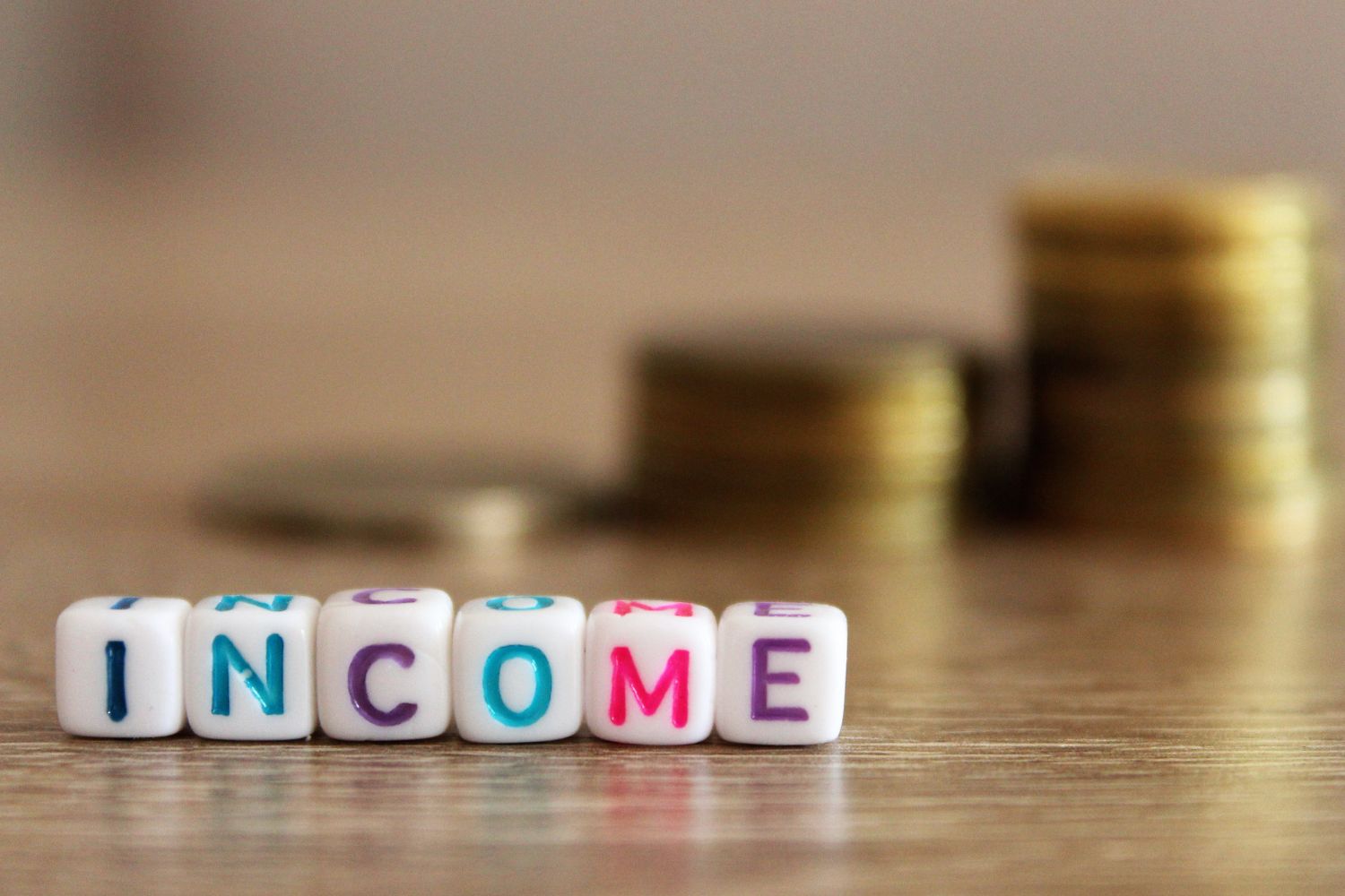 Photo of coins and income wording.
