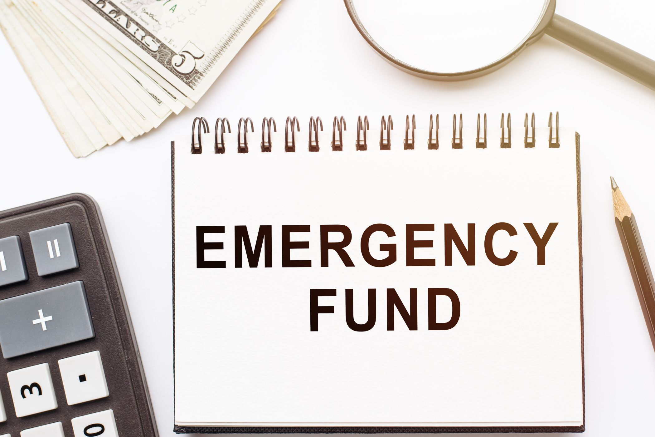 The picture shows a notebook with emergency fund wording.