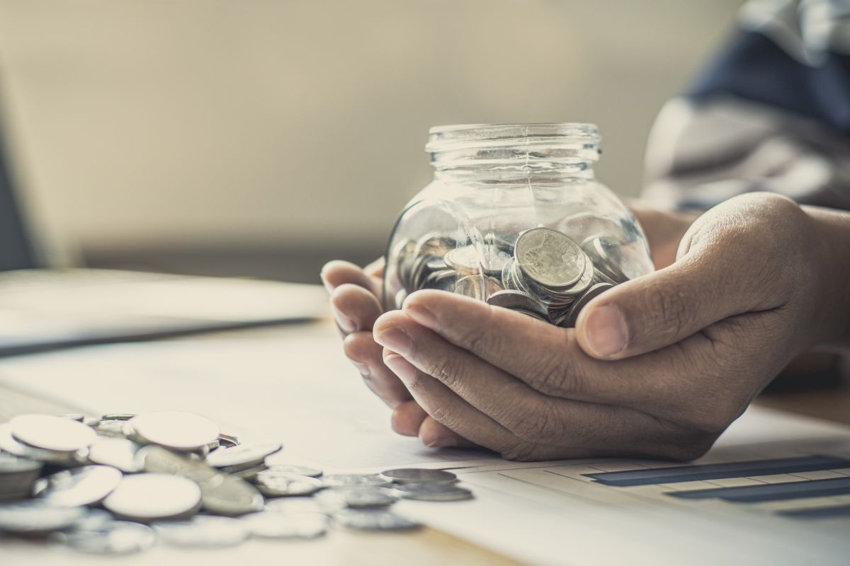 A man's hand saves money.