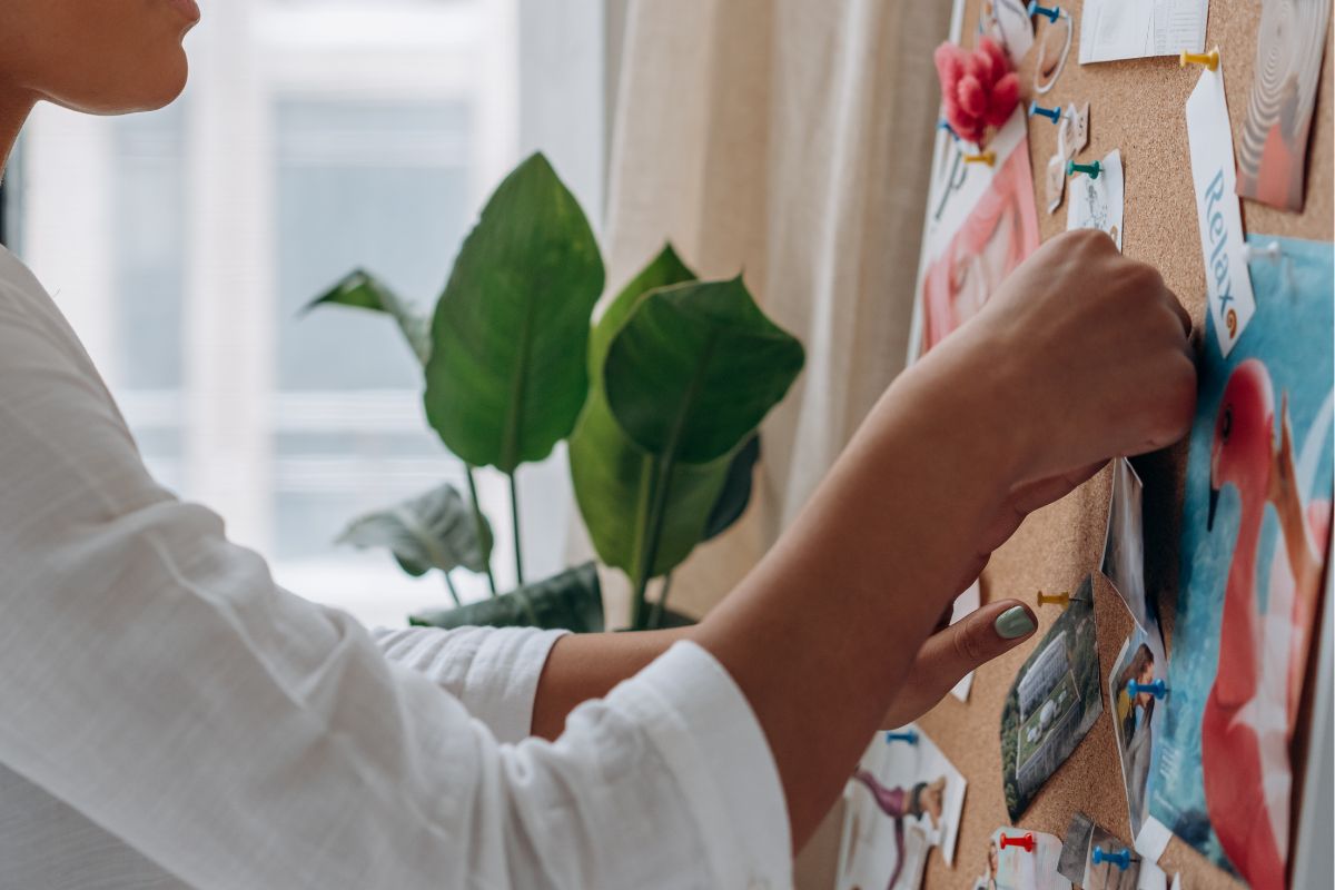A woman creating a vision board.
