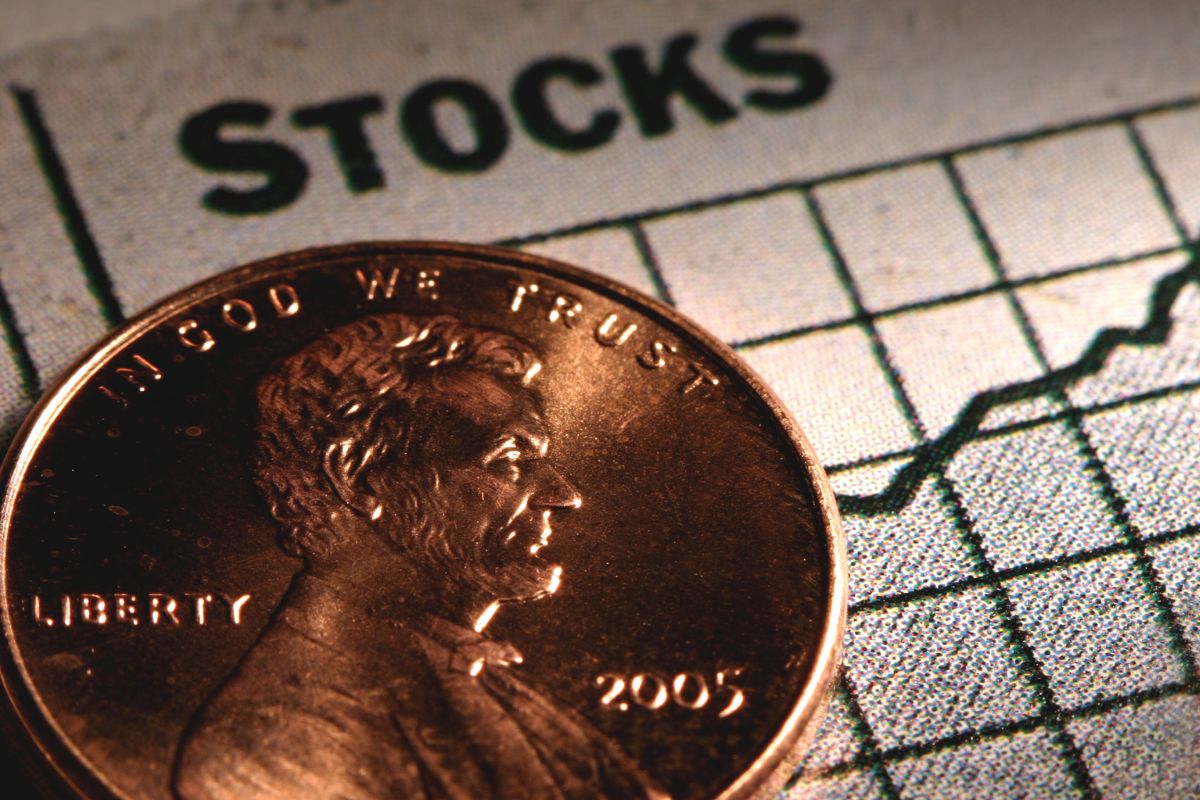 The image shows coins and stocks wording.