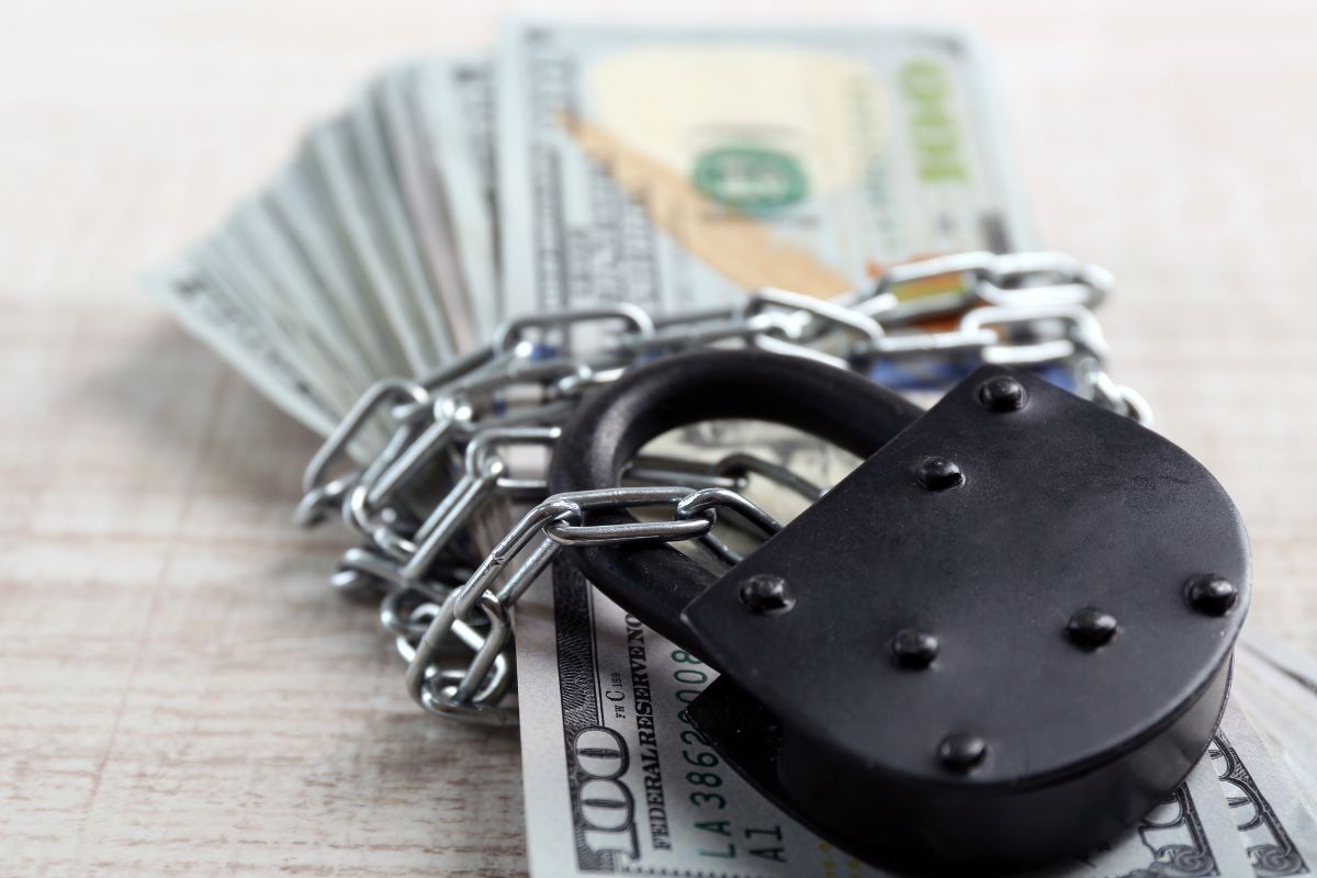 Photo of money with lock and chain.