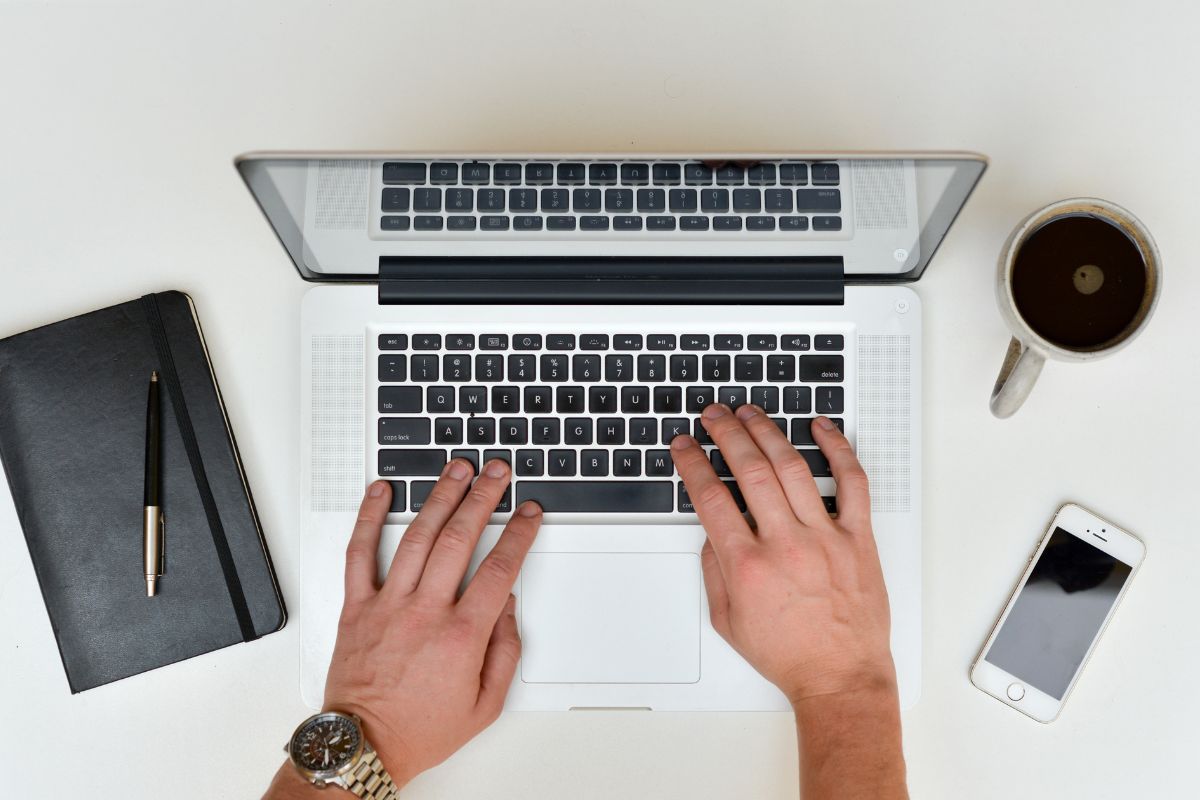 A man's hand setting up automatic contributions.