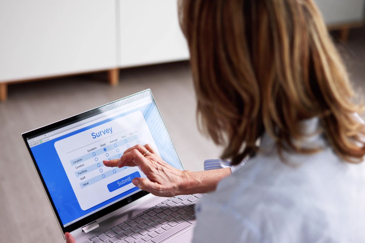 Photo of a woman taking a survey online.