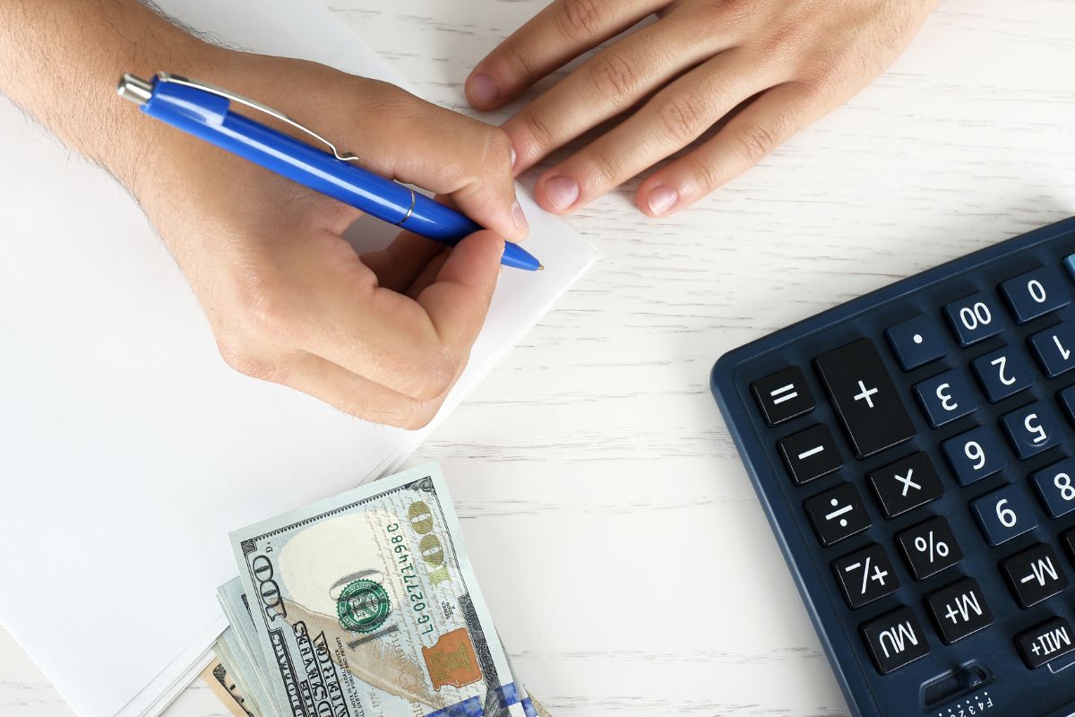 Picture of a man's hand categorizing his spending.