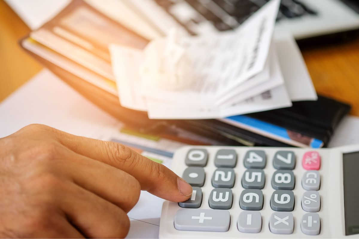 Picture of a man's tracking his expenses and income.