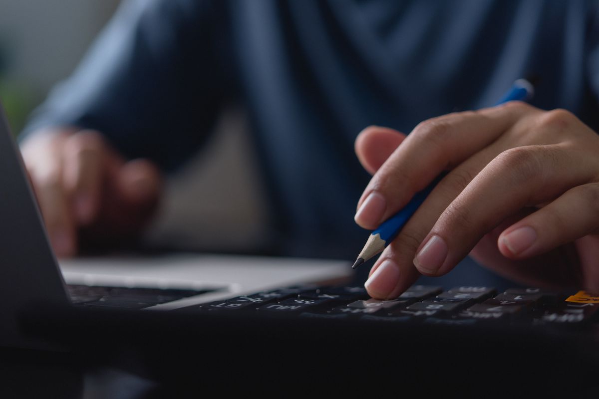 Picture of a man's hand using a budgeting tool.
