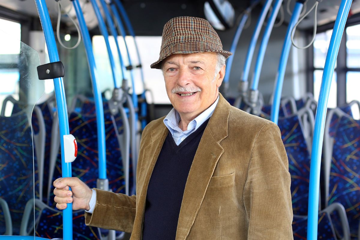 A senior man using public transportation.