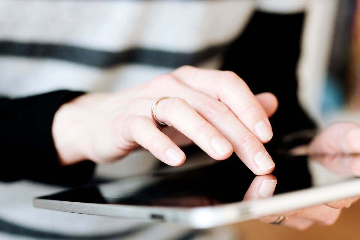 Picture of a woman's hand reviewing her subscription.