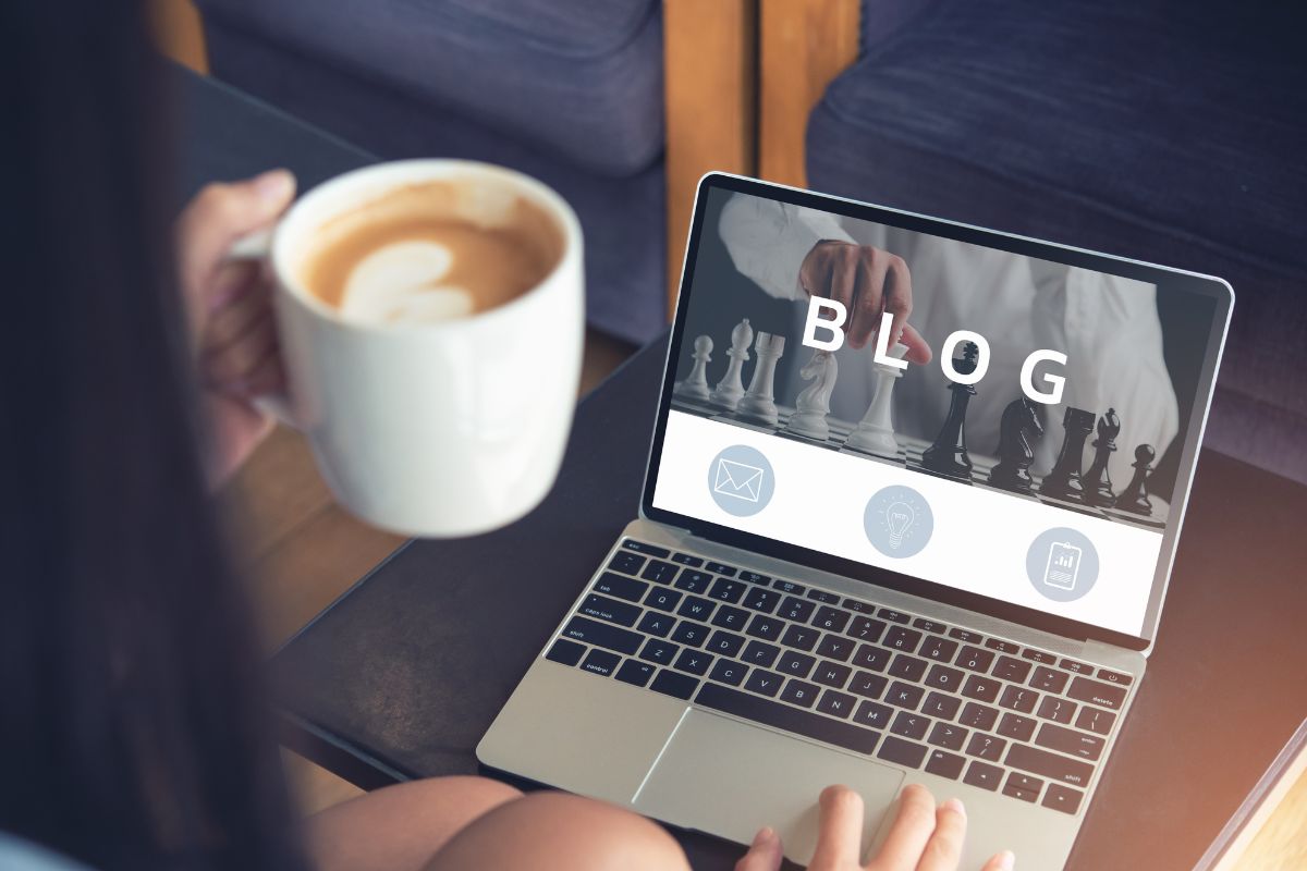 Image of a woman blogging and having a coffee.