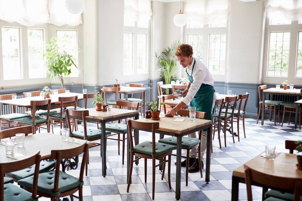 The picture shows a man serving in a local restaurant.