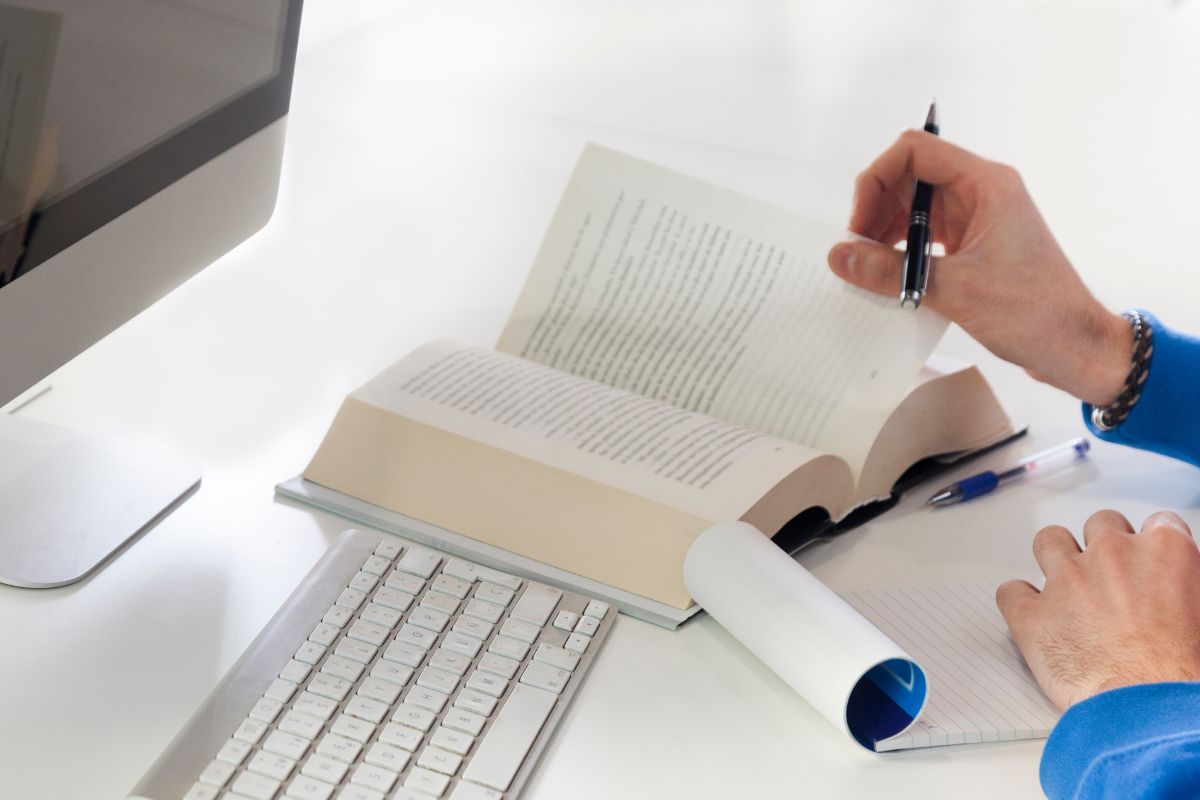 Picture of a man's hand working as transcription.