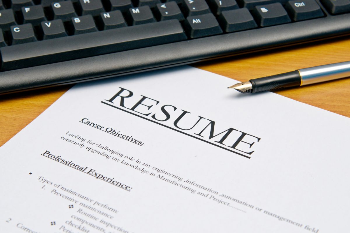 Picture of a keyboard and a resume paper.