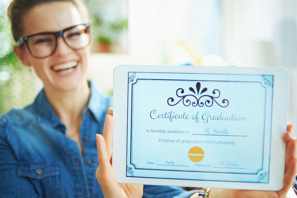 Photo of a woman holding a certificate.