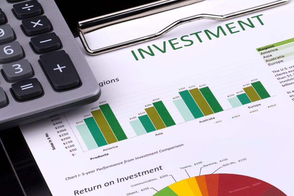 The image tells about a calculator and a piece of paper with graphs and notes indicating diversifying investments helps balance risk  and unlock new opportunities.