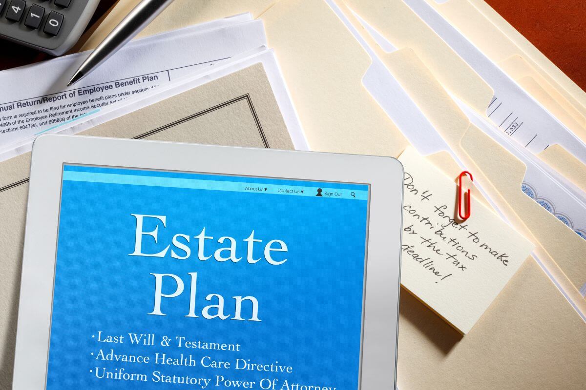 The picture of folders with papers, a calculator, a pen, and a tablet with a screen display indicating to ensure you estate plan is comprehensive to avoid problems later.