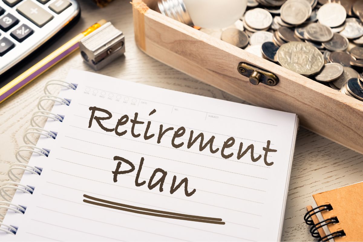Picture of coins and notebook with retirement plan wording.