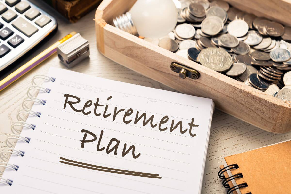 The picture tells about a calculator, a wooden container with coins, a notebook, a pen, and a notebook with notes indicating to consider early retirement planning that bring you joy wile still provising financial stability.The picture tells about a calculator, a wooden container with coins, a notebook, a pen, and a notebook with notes indicating to consider early retirement planning that bring you joy wile still providing financial stability.