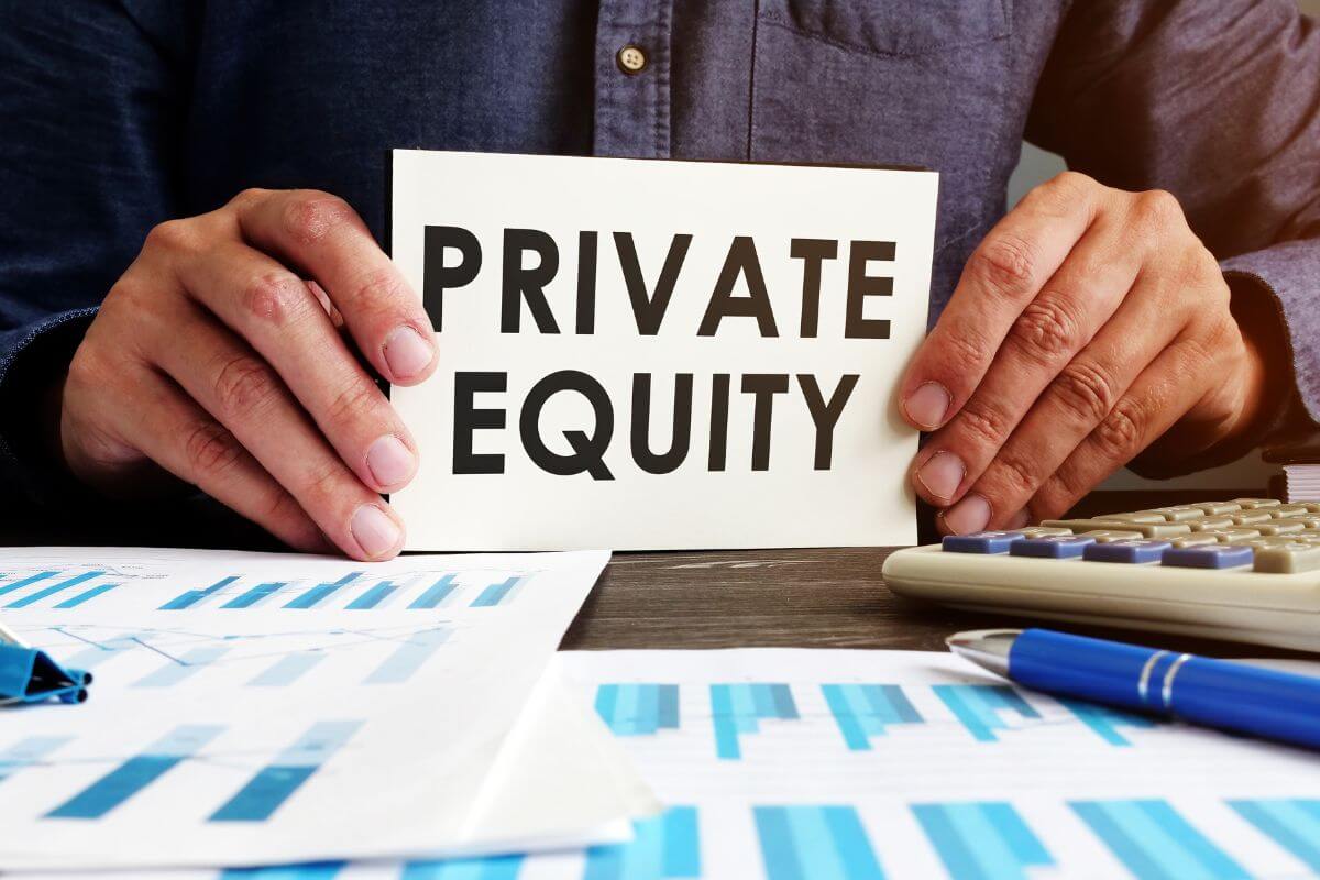 The image shows papers with graphs, a pen, a calculator, and a man's hand holding a piece of paper with notes referring to exploring opportunities for private equity investment which can diversify your portfolio and offer significant growth potential for your wealth.