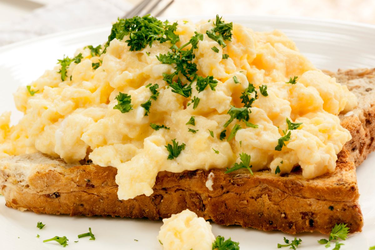 Photo of a bread with scrambled eggs.