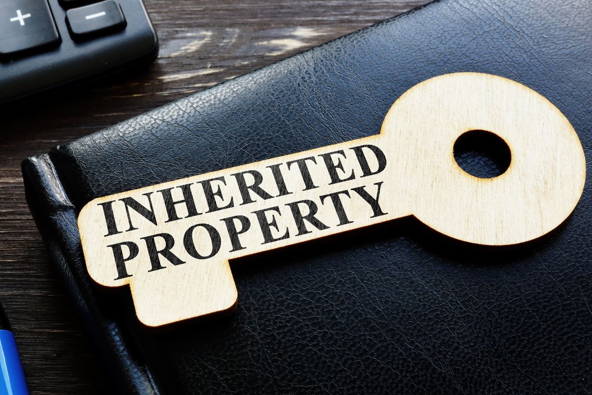 The photo shows a paper key with inherited property wording.