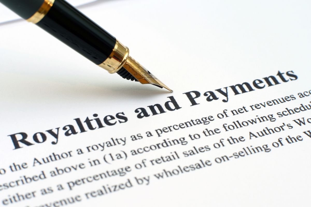 Image of a pen and paper with royalties and payments wording.