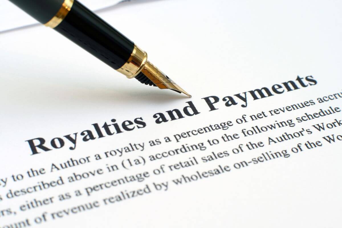 The picture tells about a pen and a piece of paper with notes indicating profiting from royalties or licensing deals to generate income for years.