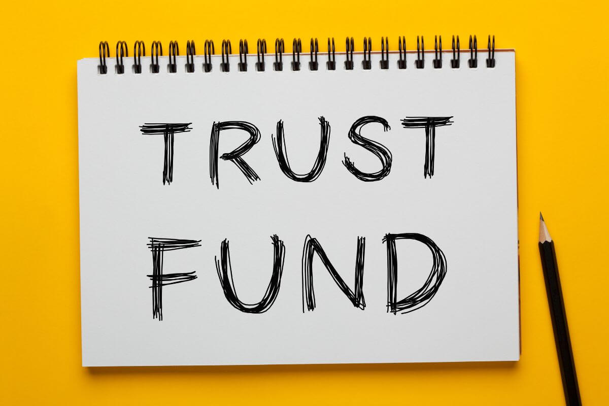 The photo of a pen and a notebook with notes refers to establishing trust funds to grow money and preserve it for future generations.