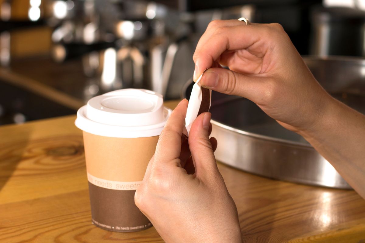 Photo of a woman's hand ordering a coffee.
