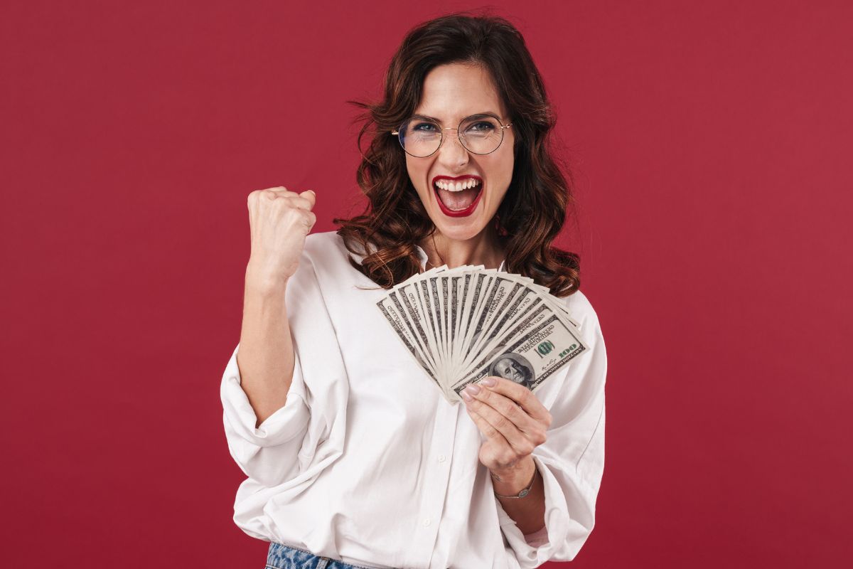 Photo of a woman holding money.