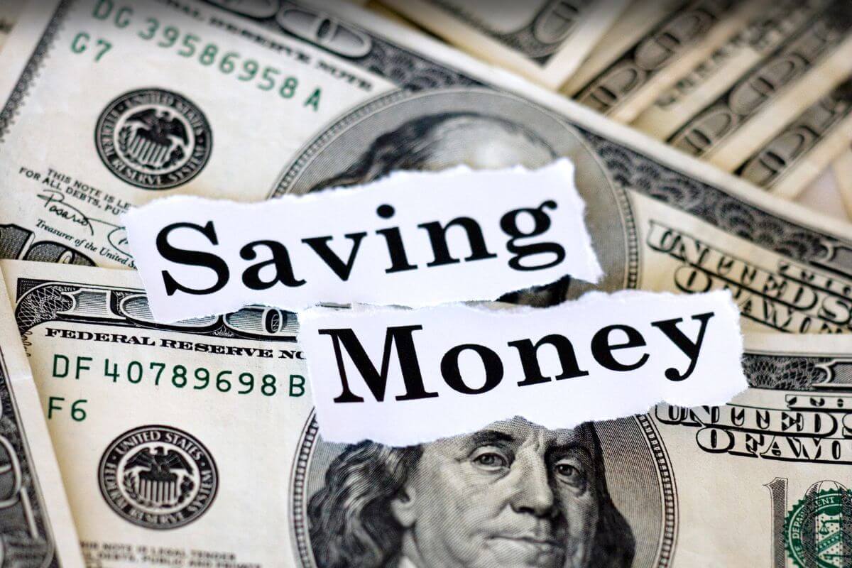 The photo shows dollar bills and papers with notes indicating treating savings as optional will fail you to create long-term financial security.
