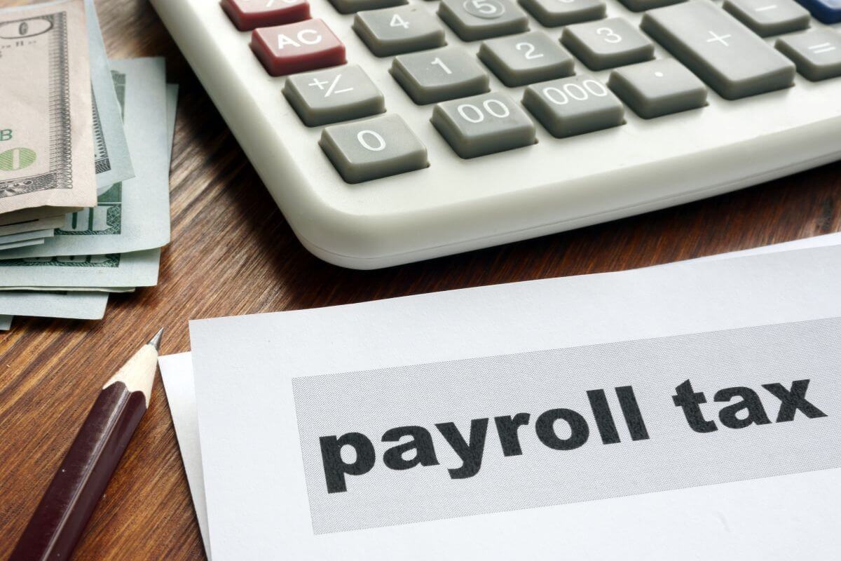The picture shows a calculator, dollar bills, a pen, and papers with notes referring to how once you retire, you no longer need to worry about payroll taxes which gives you more room to enjoy your retirement savings.