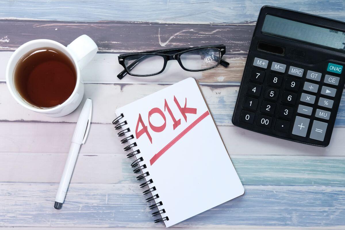The picture shows a calculator, a coffee, an eyeglass, a pen, and a notebook with notes referring to open a retirement account can give your savings a home to grow.