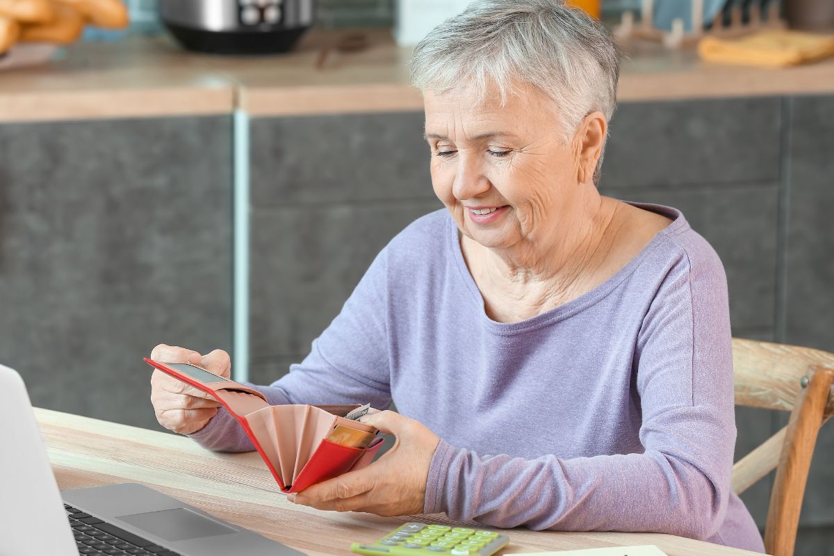 Image of a senior woman paying off her debt.