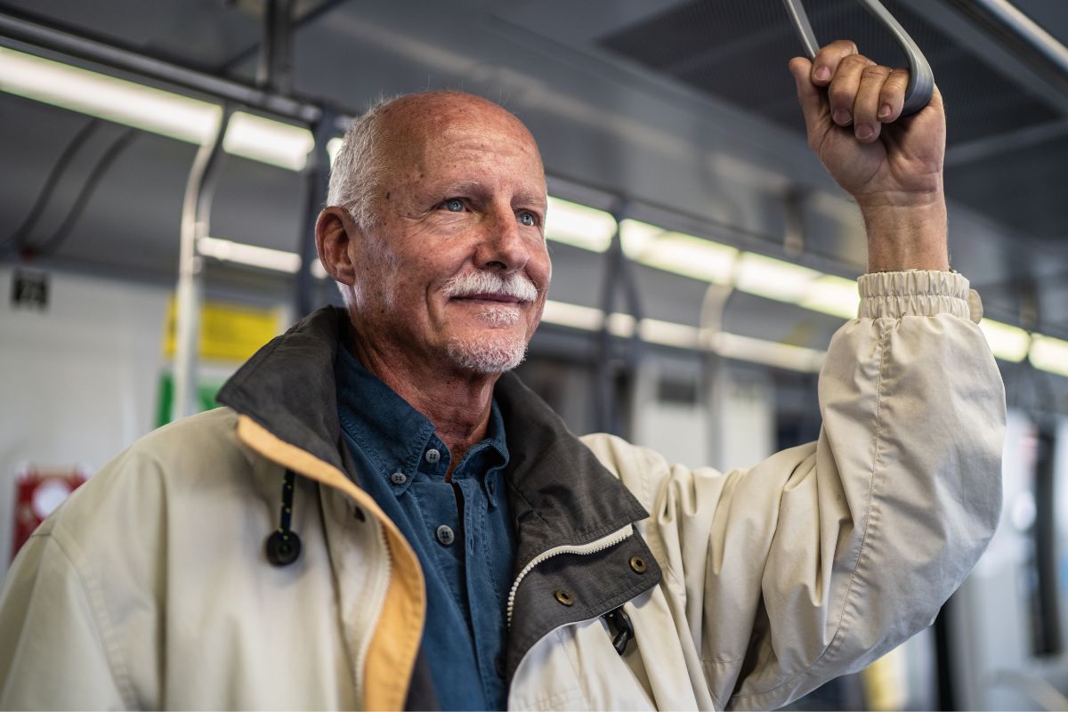 A senior man on a train.