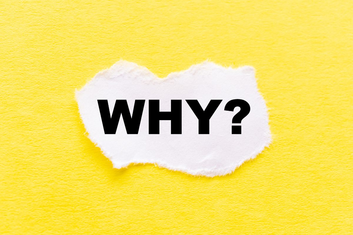 The image shows a piece of paper with a note on the yellow background which means why manifestation is important and its factor to your finances.