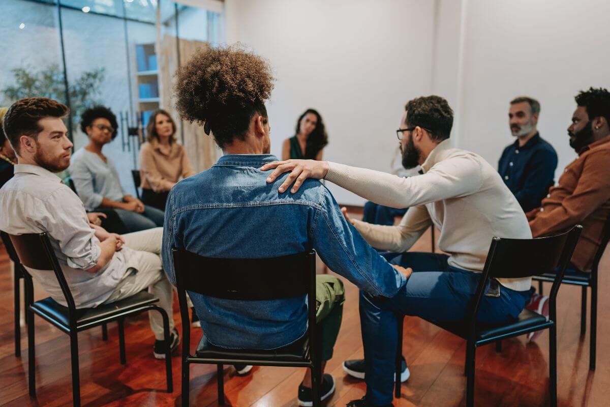 The picture shows a group of people forming a circle together which means to surround yourself with financially successful individuals for growth and better decisions.