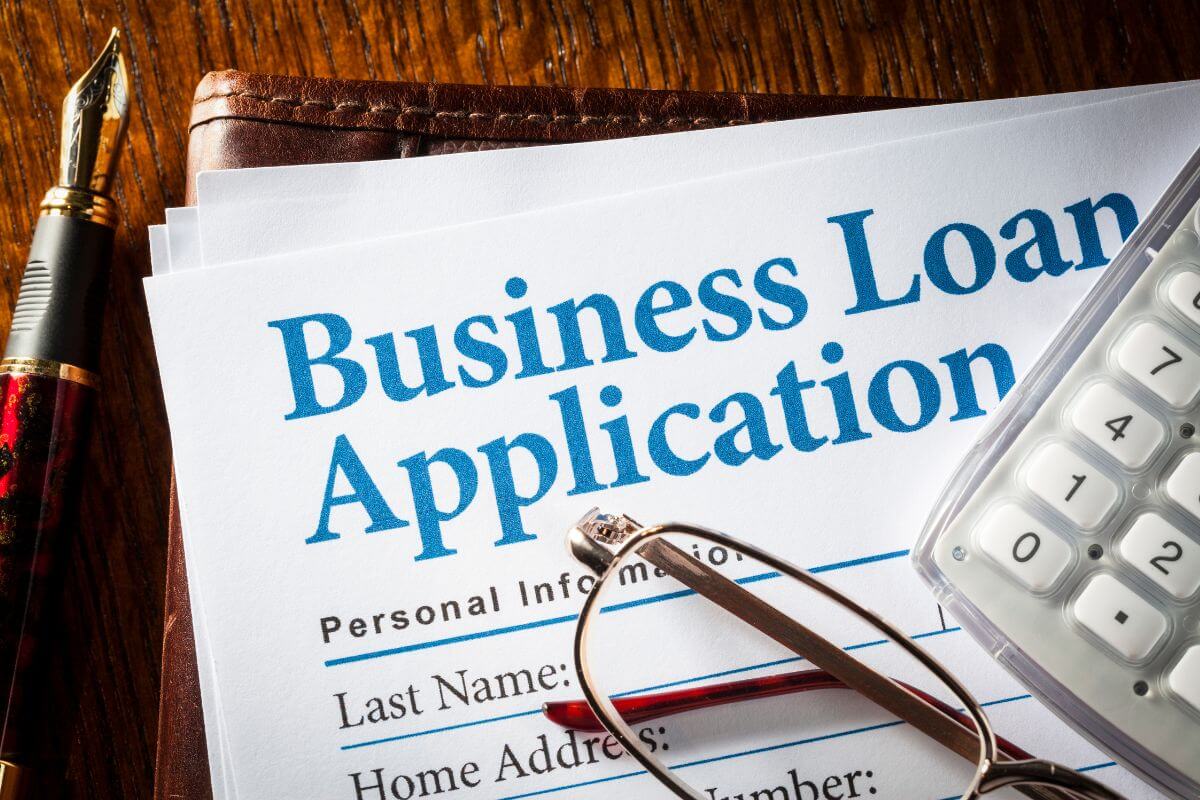 The photo tells about a pen, a calculator, an eyeglass, and papers with notes indicating to the examples of good debt that comes with manageable rates and offers opportunities to grow wealth.