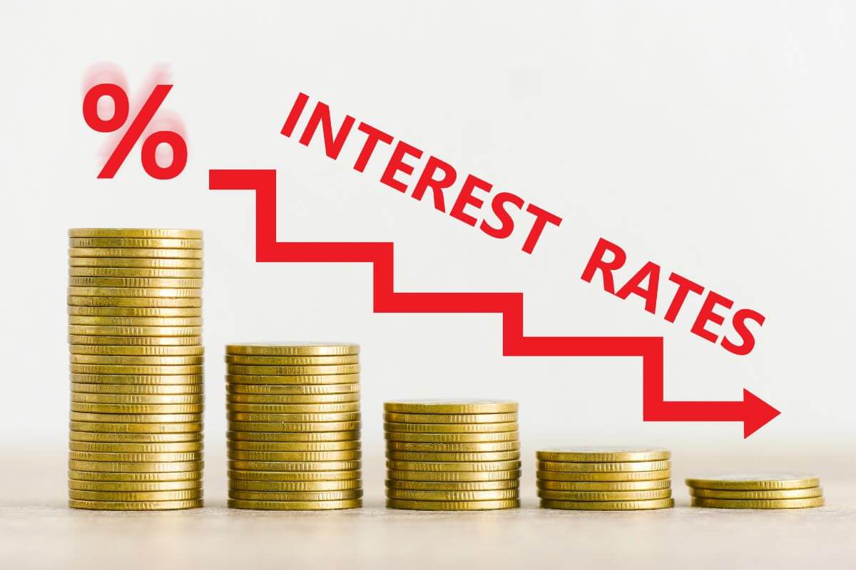 The picture tells about coin stocks, arrow down, red percentage, and red notes which means good debt often comes with low interest rates that benefit you financially over time.