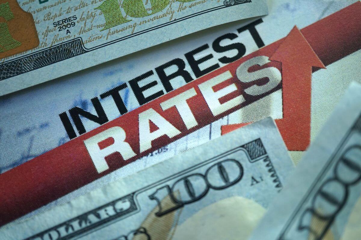 The photo tells about dollar bills, rising arrows, and notes indicating that bad debt typically carries high interest rates and can cost you more in the long run.