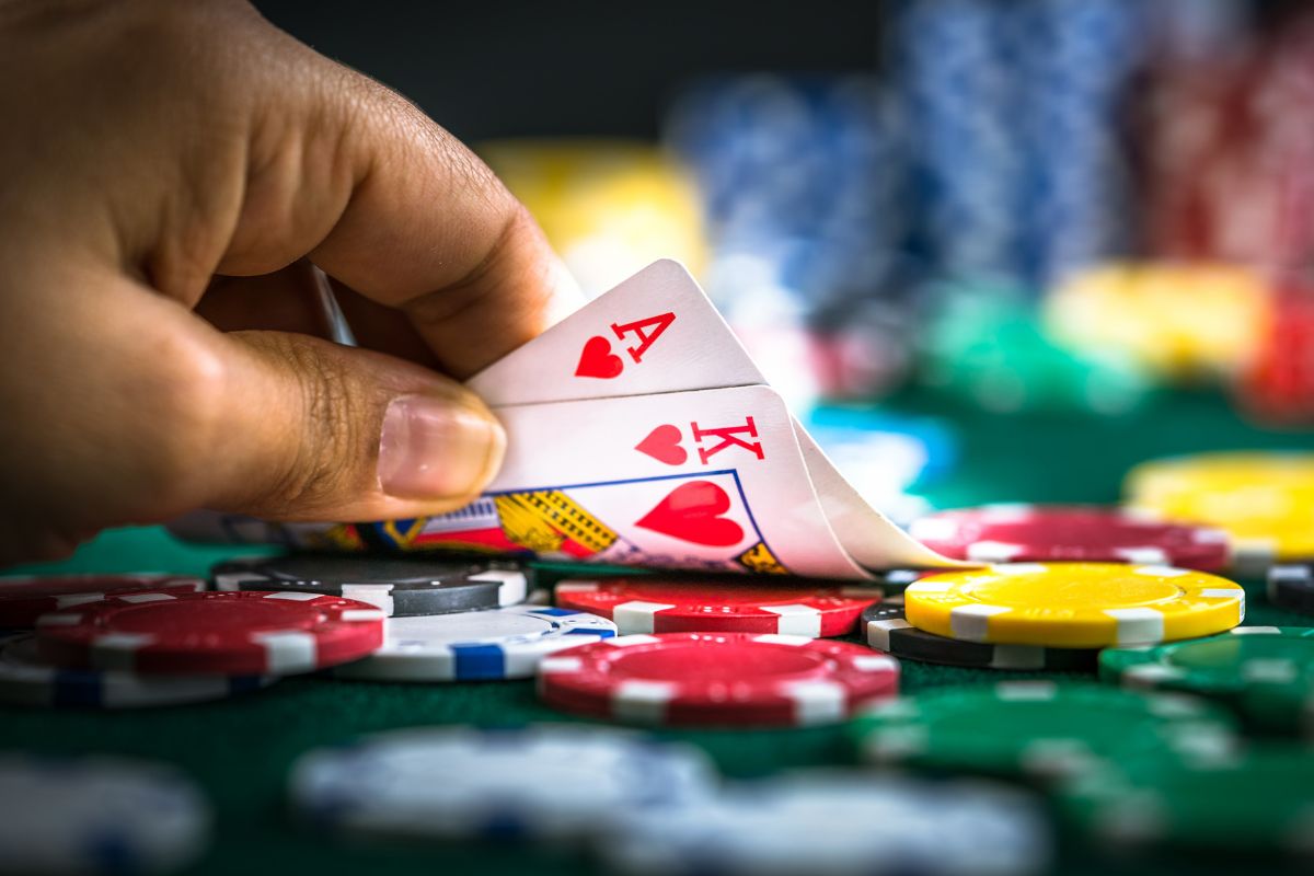 Photo of a man's hand gambling.