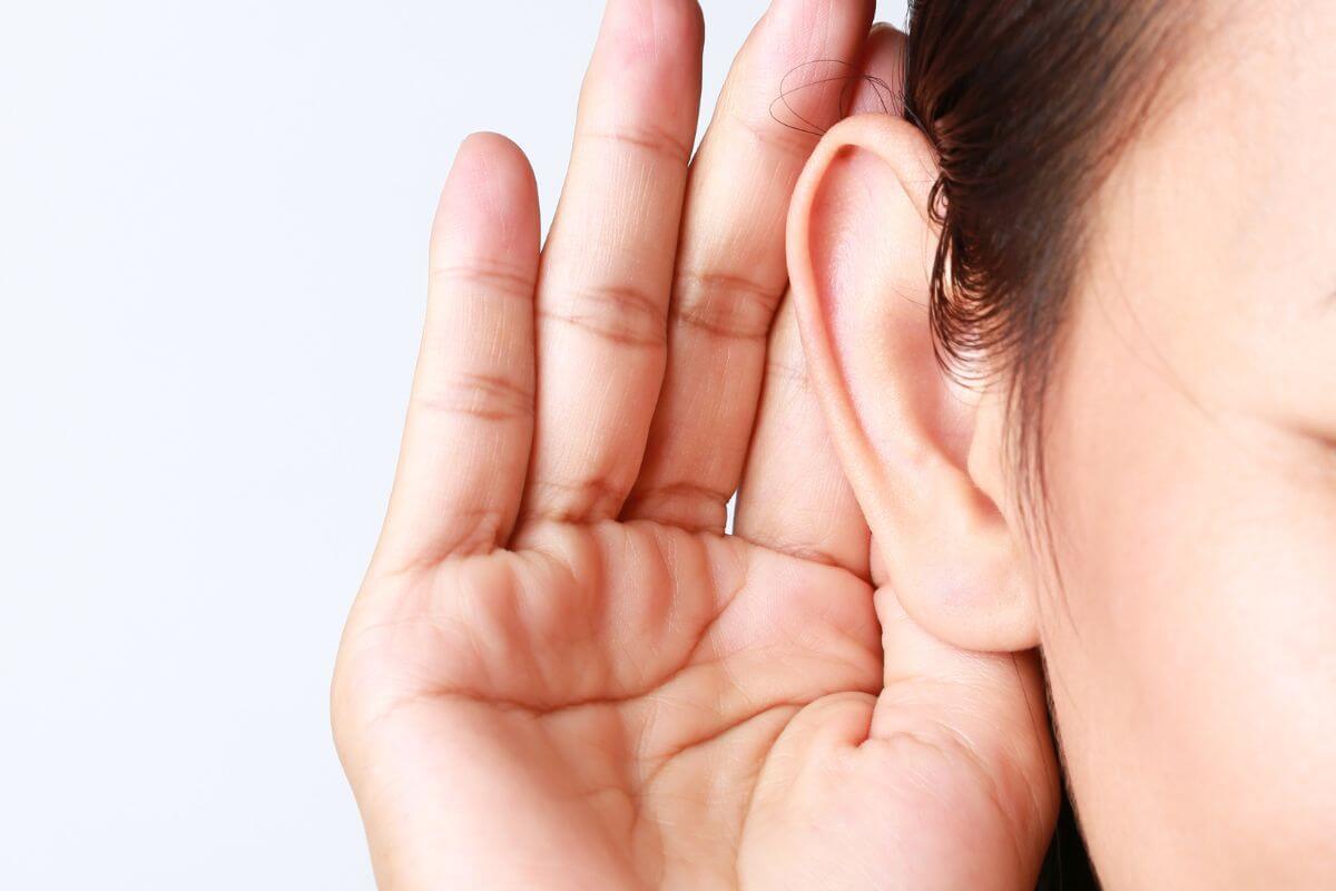 The picture shows a girl's hand placing her hand on her ear saying if it sounds too good to be true then protect your hard-earned cash by making informed decisions and avoiding scams.