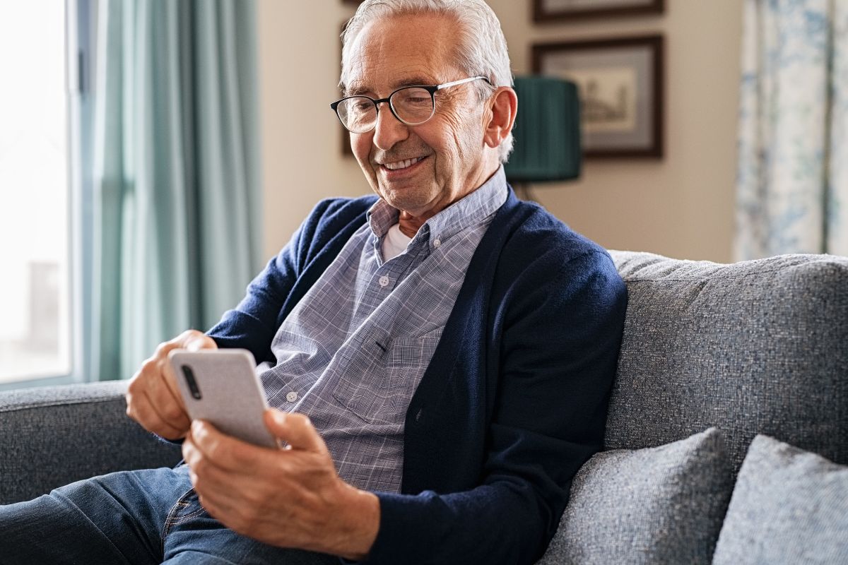 The image of a senior man using a phone.